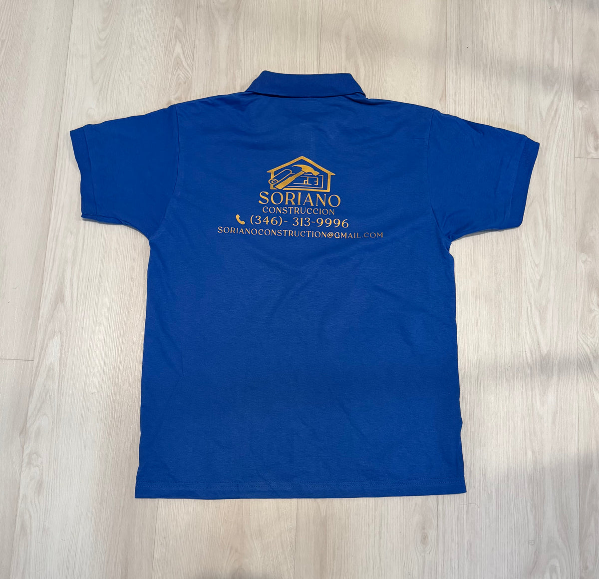 Back of a completed blue Soriano polo with a custom logo