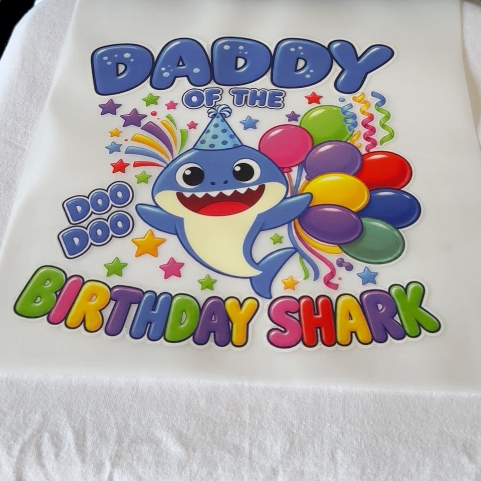 Close-up of a white birthday shirt with a colorful printed design