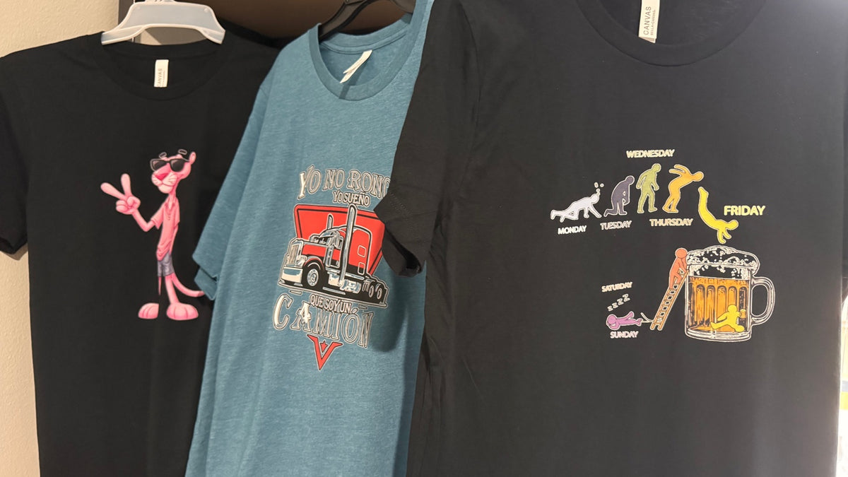 Three hanging shirts with colorful printed designs