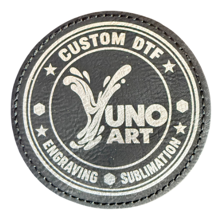 Dark circular stitched patch engraved with the YUNO ART logo